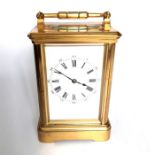 A French gilt brass striking carriage clock, white dial with Roman numerals, carrying handle, 14cm