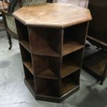 A Heal’s style oak octagonal bookcase, shaped top with chamfered edge, fitted shelves to each face