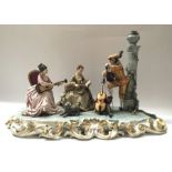 A Capodimonte porcelain figure group, musicians in court setting, on oval base with relief moulded