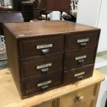 An early 20th century oak desk top six drawer filing cabinet, 56cm wide