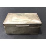 A George V silver mounted cigarette box (A/F), London 1917, cuboid form, 14cm long, 9cm wide, 5cm