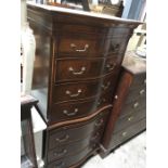 A mahogany serpentine front chest on chest, two short over six long drawer, with brushing slide.