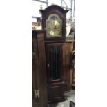 A mahogany cased grandmother clock, moo praise brass dial above glazed door on cockbeaded panelled