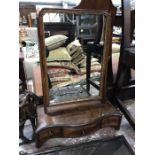 A George III mahogany toilet mirror, serpentine base fitted three drawers on bracket feet, 61.5cm