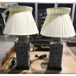 A pair of ceramic table lamps, square form, blue and white foliate lozenge patterned decoration,