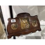 An Art Nouveau bronze plaque group of a mother and children on a rosewood easel back mount