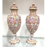 A pair of Samson famille rose vases and covers, wrythen fluted pedestal urn form, painted in the