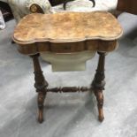A Victorian walnut sewing table, ogee moulded lid, fitted cedar lined interior with fret carved