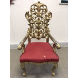 A set of ornately carved and gilded Florentine style dining chairs, the pierced foliate scroll backs