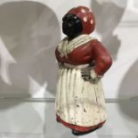 A cast iron piggy bank, modelled as a 'mammy' blac