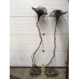 A pair of sculptural wire work standard lamps, organic flower form with spun wire shades on
