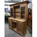 A pine dog kennel dresser, glazed doors over recess flanked by cupboard doors, 153cm wide