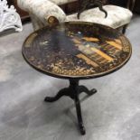 A circular tip-up occasional table decorated in the Chinoiserie style, on baluster column and