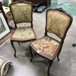 A pair of French walnut framed salon chairs, carved anthemion decoration on slender carved