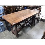 An antique Spanish chestnut hall table, lyre carved end supports, block stretcher, 70 by 135cm