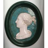 A pair of ceramic portrait plaques in the classical style, oval form, turquoise ground and painted