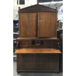 A George III mahogany, boxwood and ebony strung secretaire bookcase, angled pediment flanked by