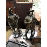 A pair of cast bronze figures modelled as cavaliers, on octagonal block base 33cm high (2)