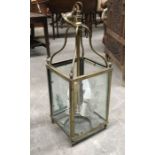 A brass hanging hall lantern, square form with bevelled star cut glass panels, ogee hanging
