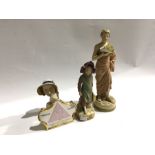 Three Royal Dux figures together with a shop advertising plaque for porcelain figurines (4)