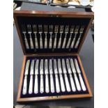 A boxed set of silver plate and mother of pearl fruit eaters, including twelve knives and twelve