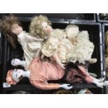 Four early 20th century and later porcelain dolls,