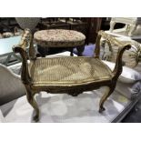 A carved gilt wood dressing table stool with woven seat on cabriole supports