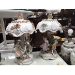 A 19th century continental porcelain lamp base modelled as figures dancing around a tree, with
