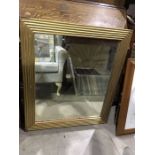 A gilt framed wall mirror, with gesso moulded reeded decoration, 92 cm high