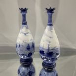 W E J Dean attributed for Royal Crown Derby, a pair of blue and white marine painted vases, footed