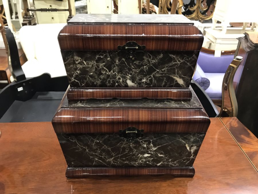 Two faux marble and wood grain caskets, largest 40cm wide