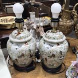 A pair of Kipfold Lighting ceramic table lamps decorated with birds and flowering branches, 35cm