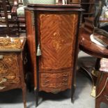 A French style marquetry inlaid drinks cabinet, serpentine form, quarter veneered door decorated