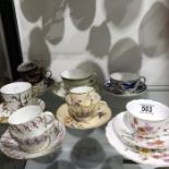 A collection of Royal Worcester teacups, trios, and breakfast cups including raised gilt aesthetic