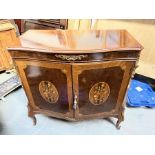 A walnut veneered and mahogany crossbanded bow front entertainment cabinet, the twin doors with