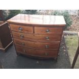 A George III mahogany and satinwood strung bow fronted chest of two short over three long