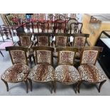 A set of Empire style dining chairs, the curved toprail carved with laurel wreath and fluted bar