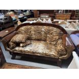 A mahogany and carved gilt wood Biedermeier sofa, faux tiger skin upholstery