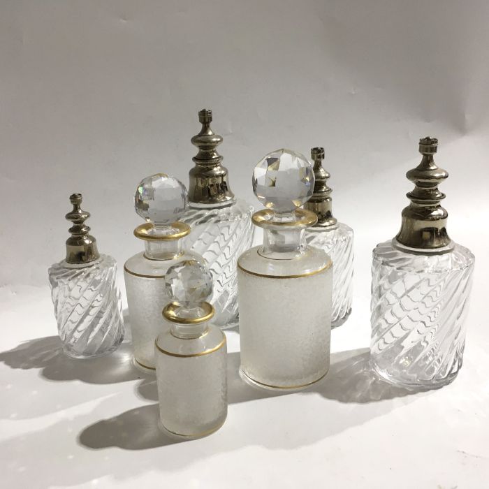 A Collection of Baccarat glass scent bottles and atomisers, including graduated set of frosted and