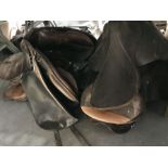 Five horse riding leather saddles, including two b