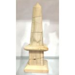 A carved stone obelisk, 25cm high