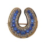 A late Victorian gold, enamel, sapphire and diamond horseshoe mourning brooch