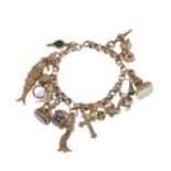 An early to mid 20th century gold charm bracelet, suspending nineteen charms