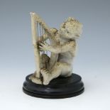Robert Wallace Martin for Martin Brothers, a stoneware musical imp figure, circa 1893, modelled