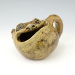 Robert Wallace Martin for Martin Brothers, a grotesque and characterful stoneware spoon warmer,
