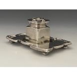 William Tonks, an Arts and Crafts silver plated inkwell, the cuboid pot with hinged lid embossed