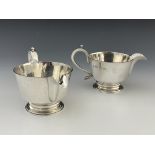 A pair of Elizabeth II silver jugs, in the Charles II style, footed conical form, ear handles, 18.5m