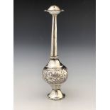 An Oriental silver rosewater sprinkler, the bulbous body embossed and chased with floral motifs,