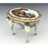 A 19th century Dresden porcelain model table, the oval top painted with a Watteau type scene of a