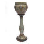 A Royal Doulton stoneware jardiniere and stand, relief moulded Art Nouveau style foliate cartouches,